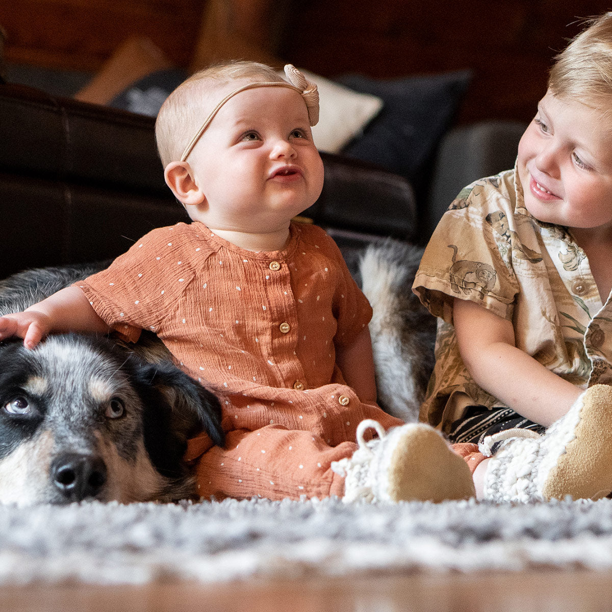 Brother and sister wearing their Padraig Slippers with their dog