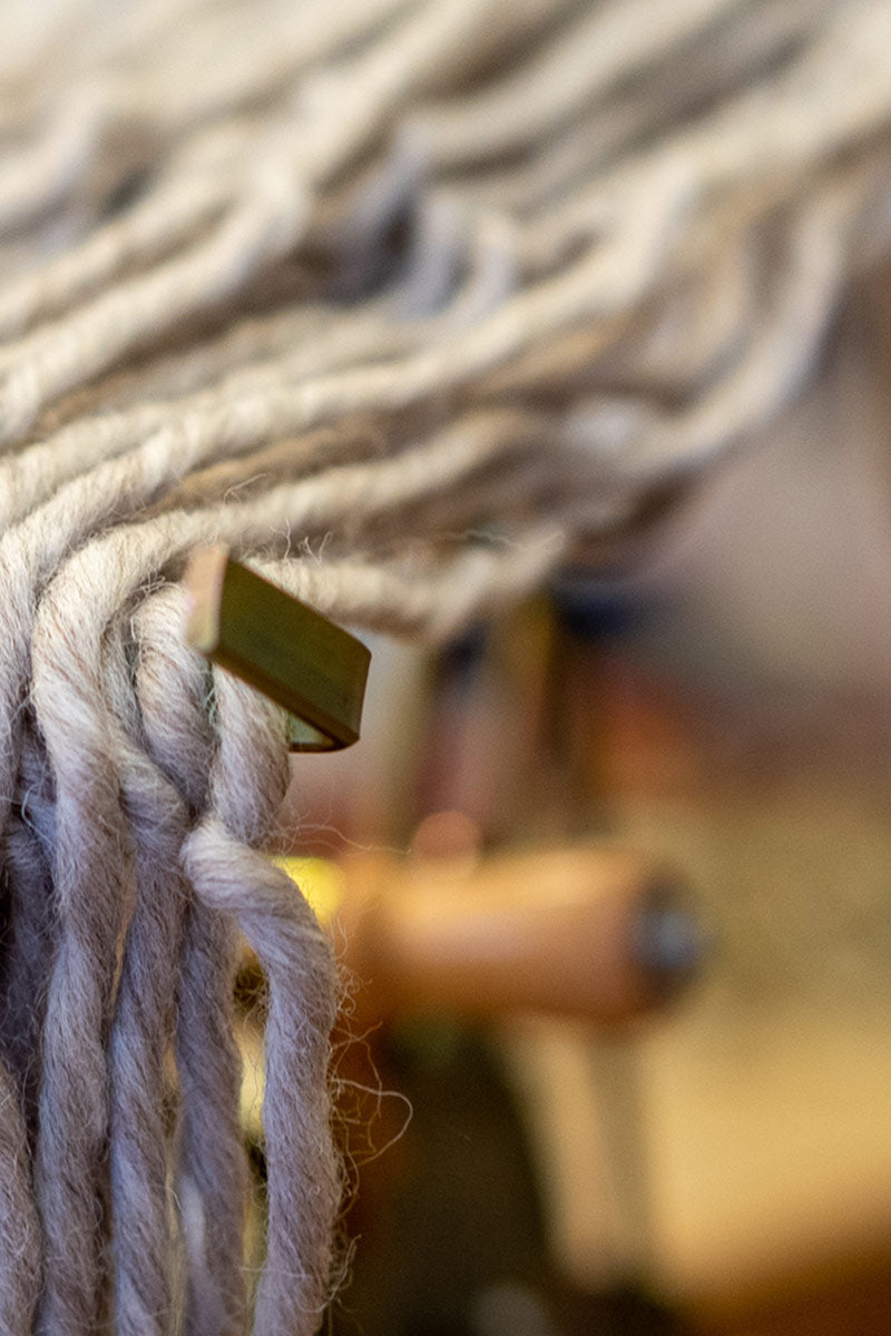 Grey wool being wound on skein