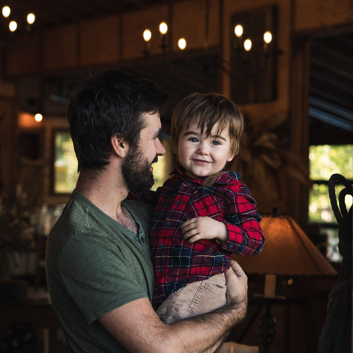 Dad holding smiling son 