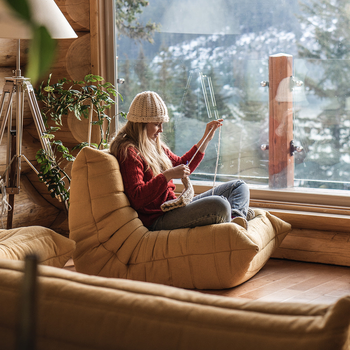 Women relaxing and knitting next to window wearing her Padraig Slippers