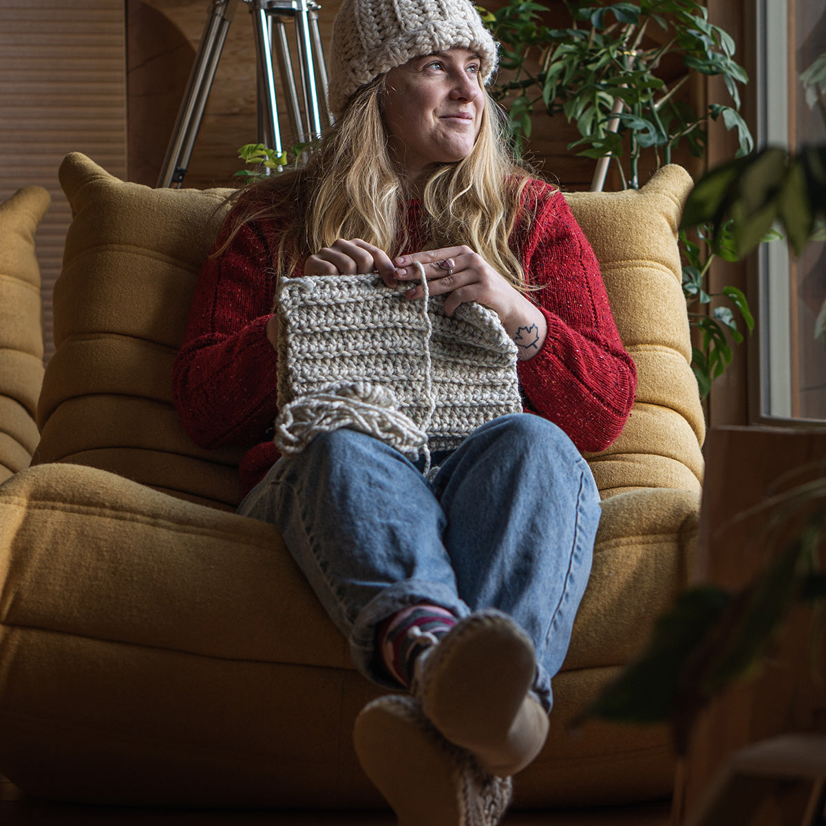 Women knitting while wearing her Padraig Slippers